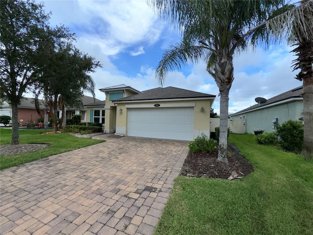 view of front of property with a garage and a front lawn