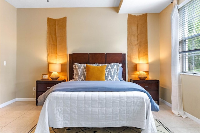 bedroom featuring light tile patterned floors and multiple windows