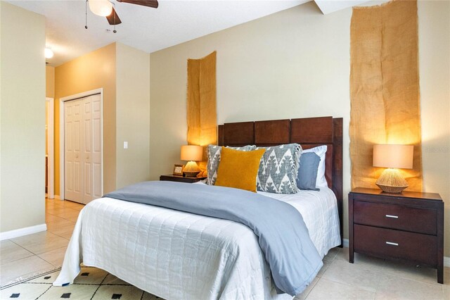 bedroom featuring a closet, ceiling fan, and light tile patterned flooring