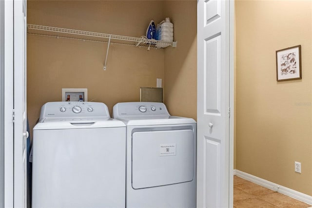 washroom with light tile patterned floors and independent washer and dryer