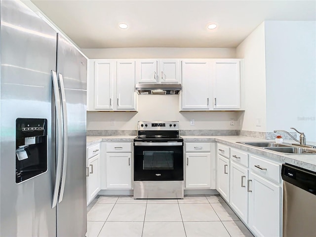 kitchen with white cabinets, stainless steel appliances, light tile patterned flooring, and sink