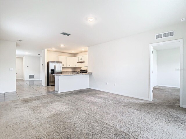 unfurnished living room with light carpet