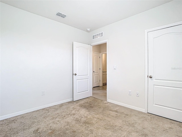 unfurnished bedroom featuring light colored carpet