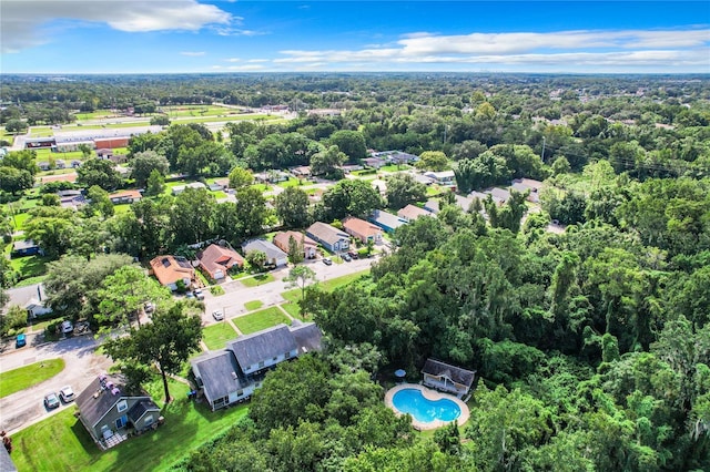 aerial view featuring a forest view and a residential view