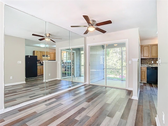 unfurnished living room with baseboards, light wood-style floors, and ceiling fan