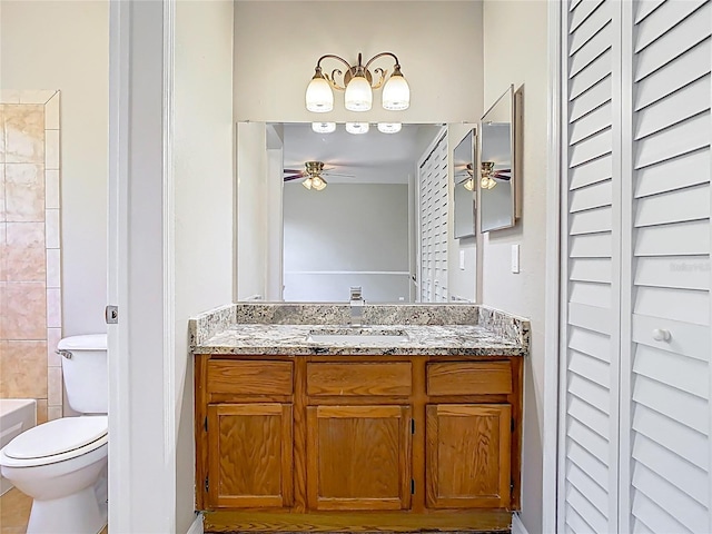 bathroom featuring toilet, vanity, and a ceiling fan