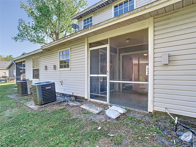 view of property exterior featuring cooling unit and a sunroom