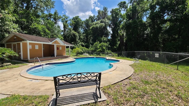 pool with an outdoor structure, a patio area, and fence