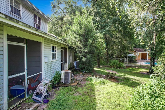 view of yard featuring central air condition unit