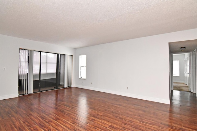 954 Courtyard Ln Unit 11, Orlando, FL 32825 - spare room with dark wood-type flooring, baseboards, and plenty of natural light