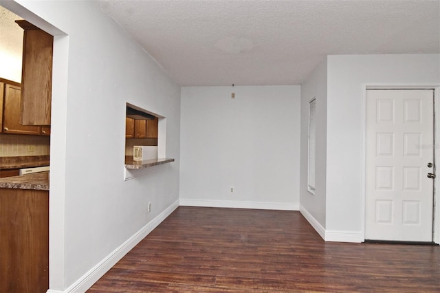 954 Courtyard Ln Unit 11, Orlando, FL 32825 - unfurnished room featuring a textured ceiling, dark wood-style flooring, and baseboards