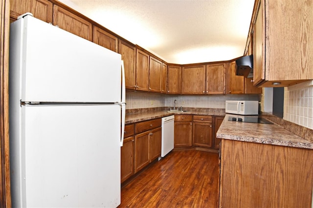 kitchen featuring white appliances, sink, backsplash, custom exhaust hood, and dark wood-type flooring