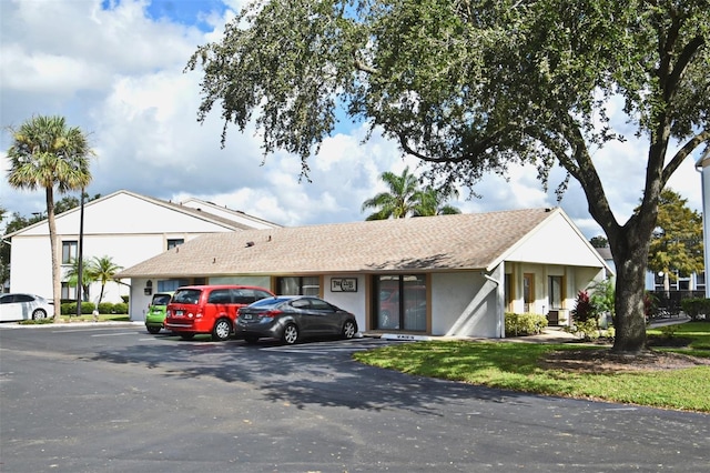 954 Courtyard Ln Unit 11, Orlando, FL 32825 - view of front of home with stucco siding and uncovered parking