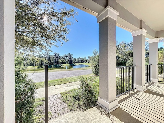 view of patio with a water view and a porch