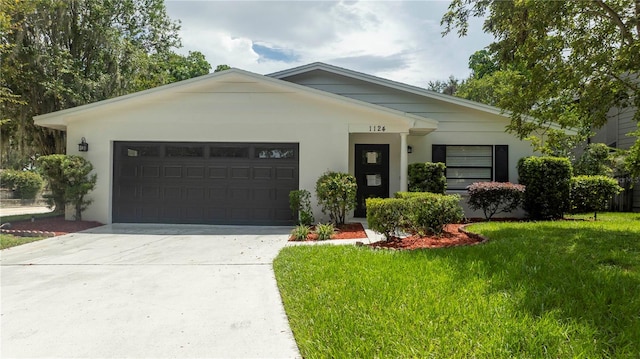 ranch-style home with a front yard and a garage