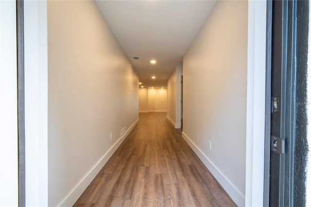 hall with hardwood / wood-style flooring