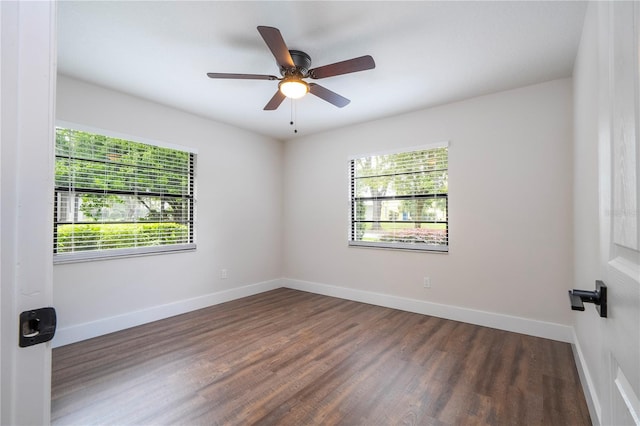 empty room with dark wood-type flooring and ceiling fan