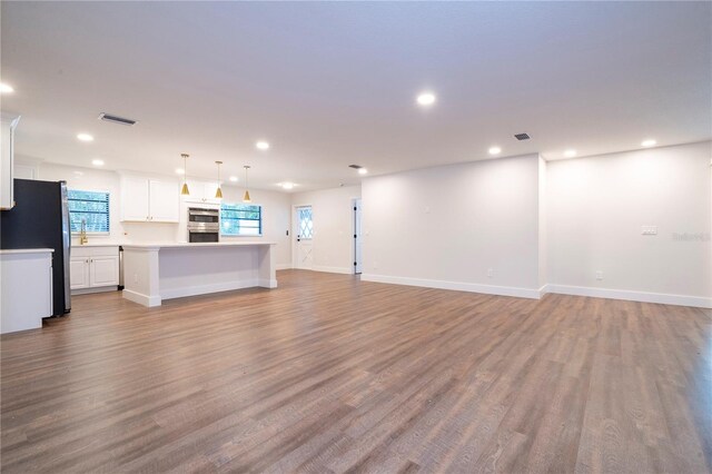 unfurnished living room with light hardwood / wood-style flooring