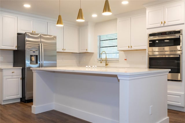 kitchen with hanging light fixtures, stainless steel appliances, dark hardwood / wood-style flooring, and white cabinets