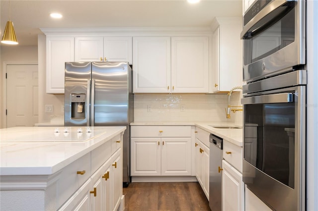 kitchen featuring stainless steel appliances, light stone countertops, dark hardwood / wood-style flooring, and white cabinets