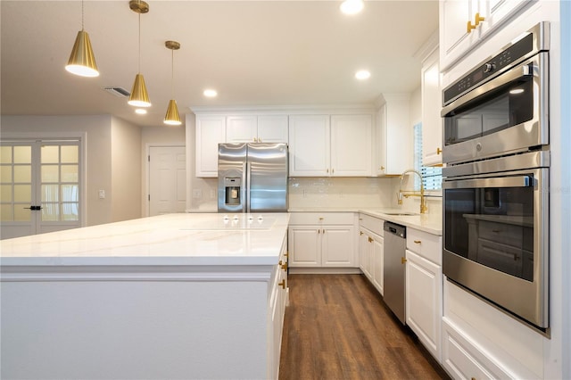 kitchen with a healthy amount of sunlight, stainless steel appliances, sink, dark hardwood / wood-style floors, and a kitchen island with sink