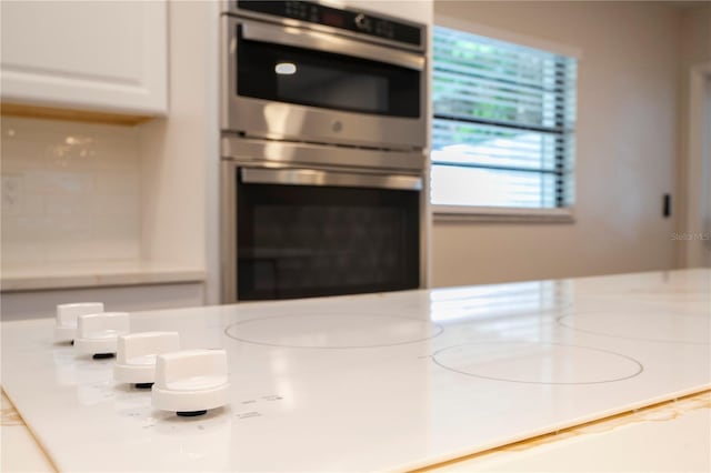 kitchen with white cabinetry and stainless steel double oven