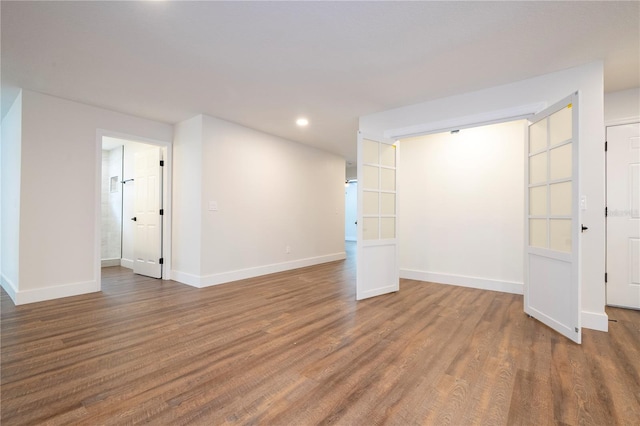 basement with hardwood / wood-style flooring