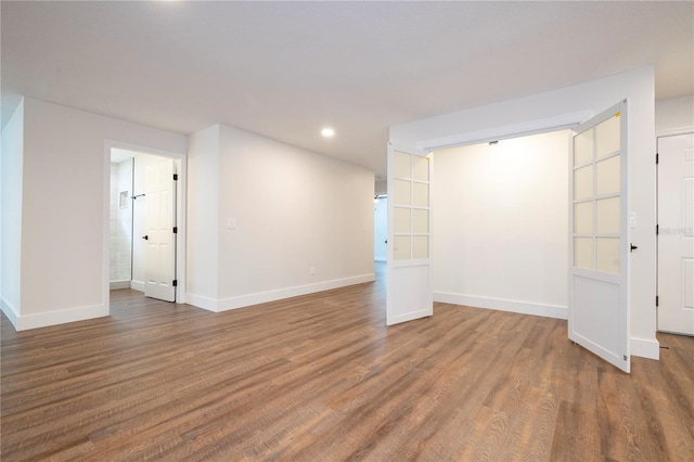 unfurnished room with recessed lighting, baseboards, and wood finished floors