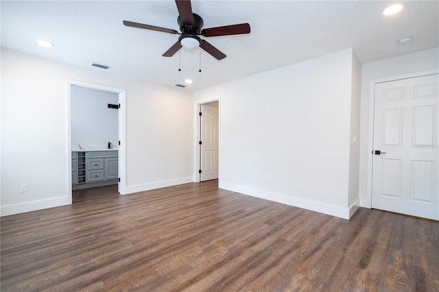 unfurnished bedroom featuring ceiling fan, dark hardwood / wood-style floors, and ensuite bathroom