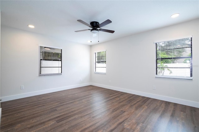 spare room featuring baseboards, recessed lighting, a ceiling fan, and dark wood finished floors