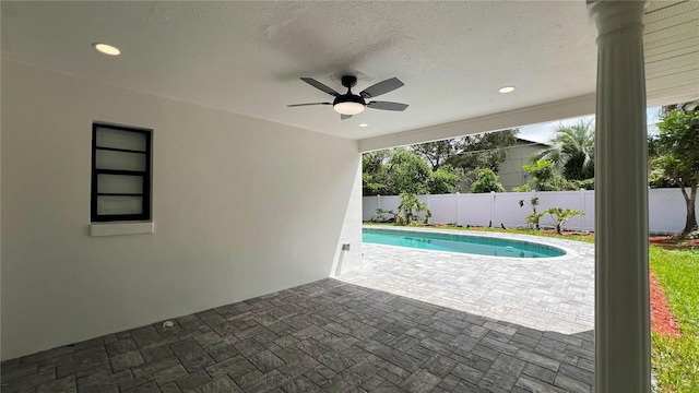 view of swimming pool featuring fence, ceiling fan, a patio area, and a fenced in pool