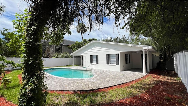 view of pool with a fenced backyard, a ceiling fan, and a patio