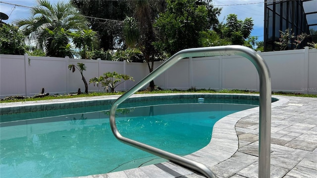 view of pool featuring a fenced in pool, a fenced backyard, and a patio area