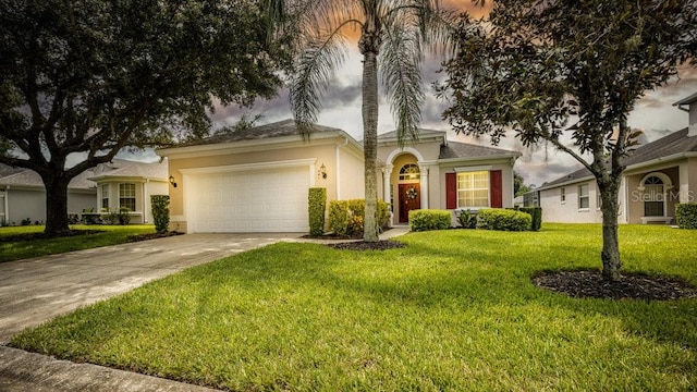 view of front of house featuring a front yard and a garage