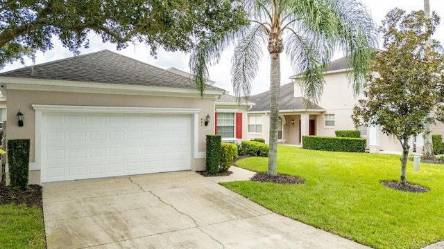 view of front facade featuring a garage and a front lawn