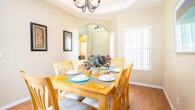 dining room featuring light hardwood / wood-style flooring and a chandelier