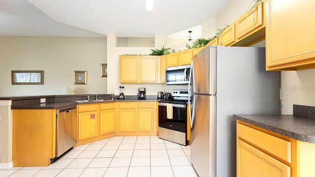 kitchen with light tile patterned floors, appliances with stainless steel finishes, kitchen peninsula, sink, and light brown cabinets