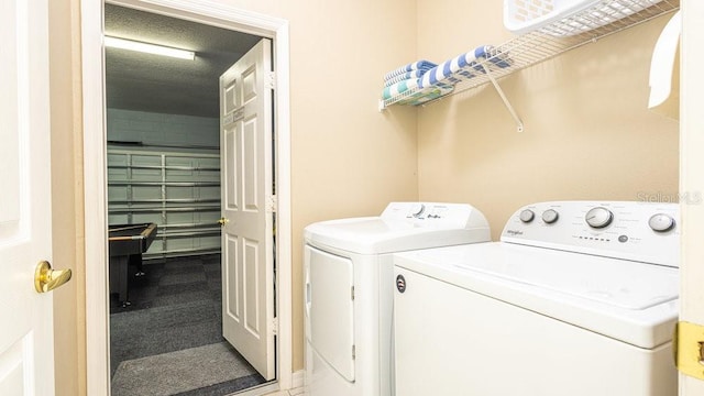 laundry room with carpet floors and washer and dryer