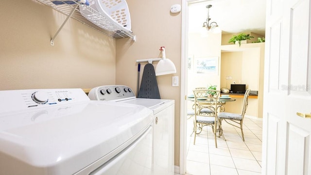 laundry room featuring independent washer and dryer and light tile patterned floors