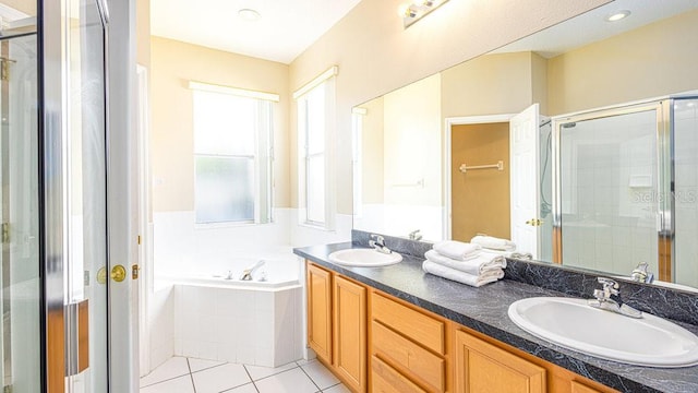 bathroom with tile patterned flooring, independent shower and bath, and vanity