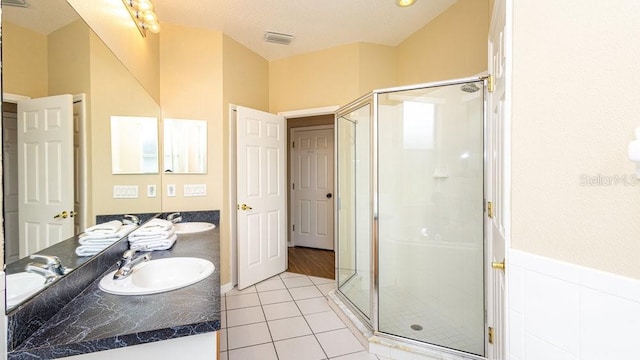 bathroom with tile patterned flooring, vanity, and an enclosed shower