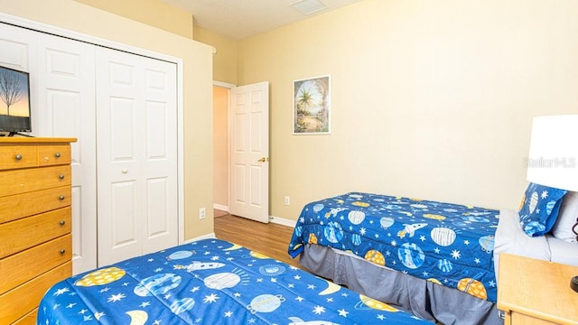 bedroom with hardwood / wood-style floors and a closet