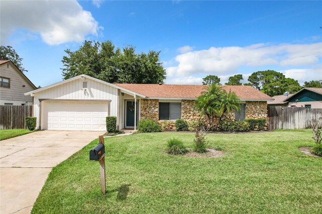 ranch-style home with a front lawn and a garage