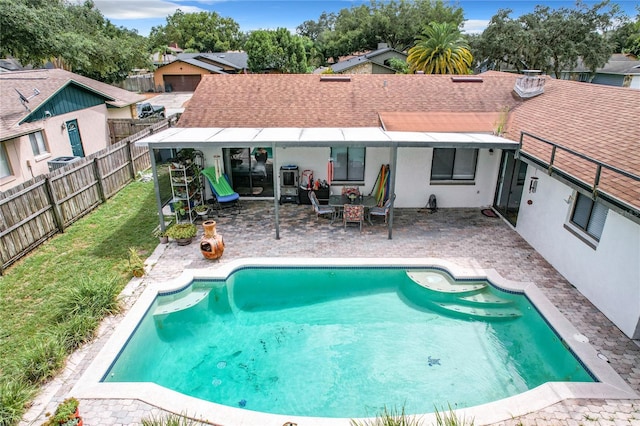 view of swimming pool with a patio