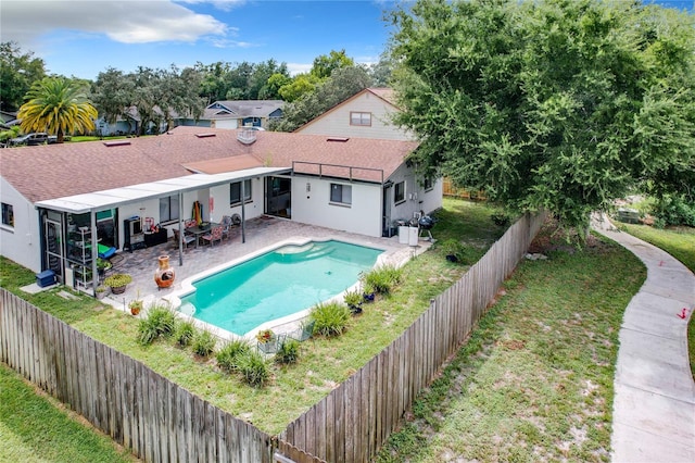 view of swimming pool with a yard and a patio