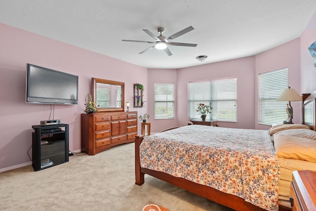 bedroom featuring ceiling fan and light colored carpet