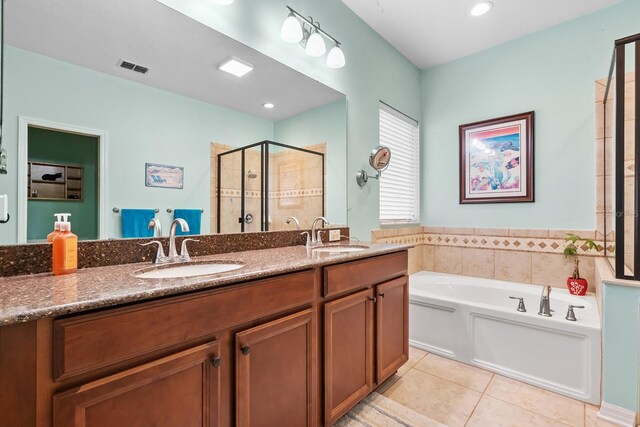 bathroom with tile patterned flooring, vanity, and plus walk in shower