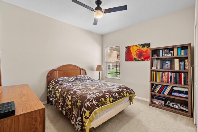 bedroom featuring ceiling fan and light carpet