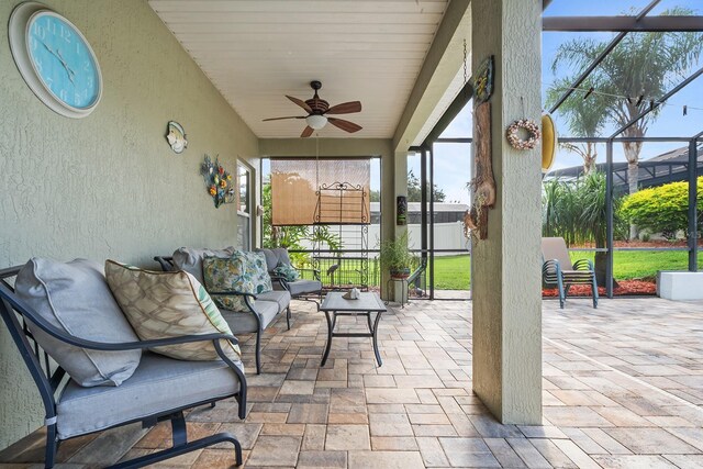 sunroom featuring ceiling fan