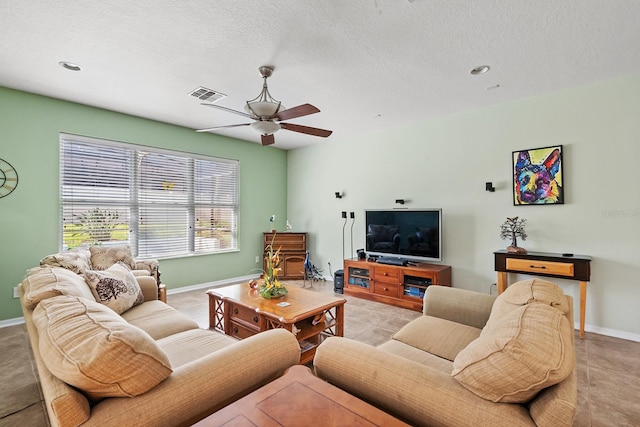 tiled living room featuring ceiling fan and a textured ceiling